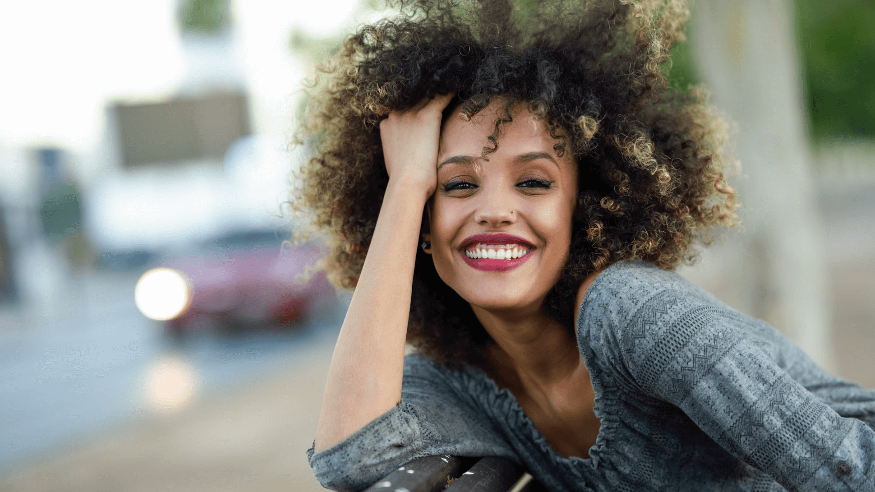 curly-haired woman smiling out